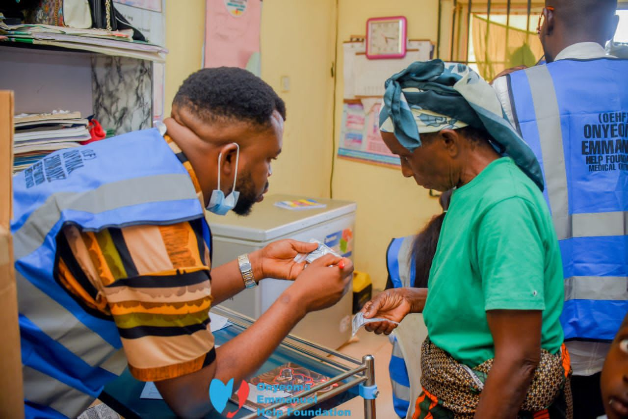 A volunteer doctor prescribing drugs for a patient at Onyeooma Emmanuel Help Foundation